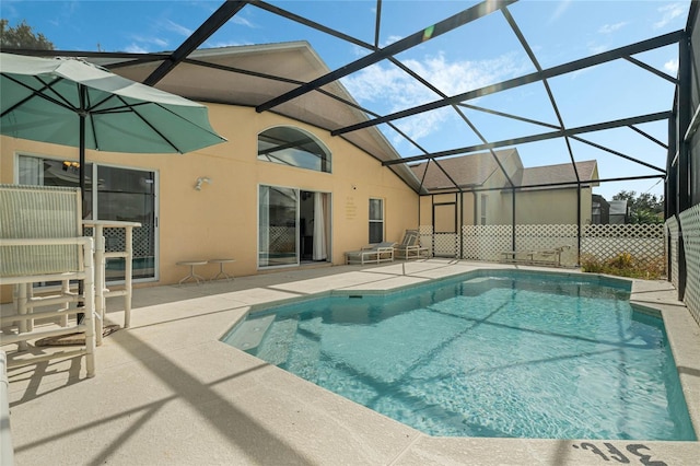 view of pool with a patio area and a lanai