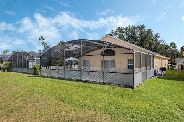 view of pool featuring glass enclosure and a lawn