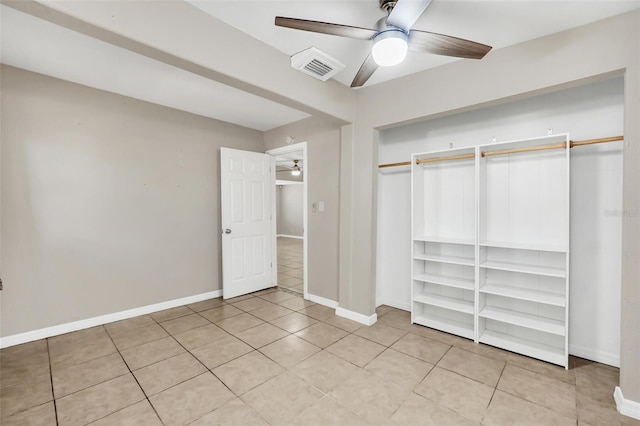 unfurnished bedroom featuring a closet, ceiling fan, and light tile patterned floors