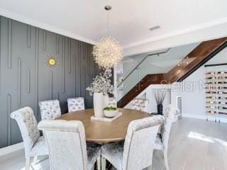 dining space with a chandelier and crown molding