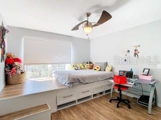 bedroom with ceiling fan and light hardwood / wood-style flooring