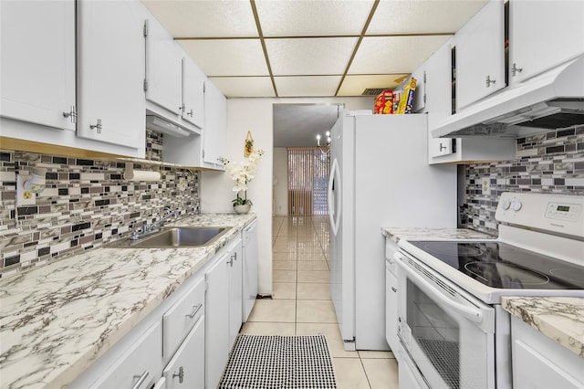 kitchen with white appliances, sink, white cabinets, decorative backsplash, and light tile patterned floors