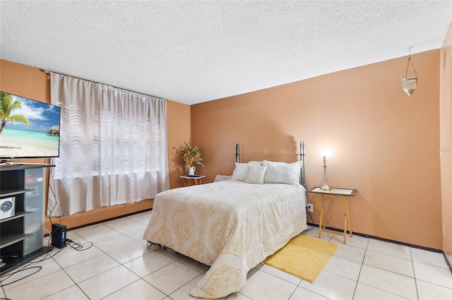 tiled bedroom featuring a textured ceiling