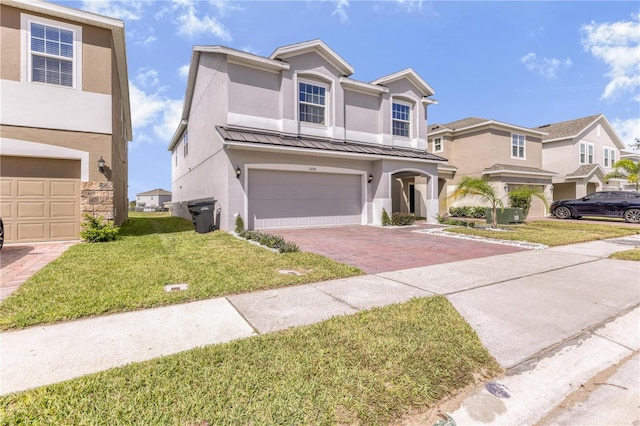 view of front of property with a front yard and a garage