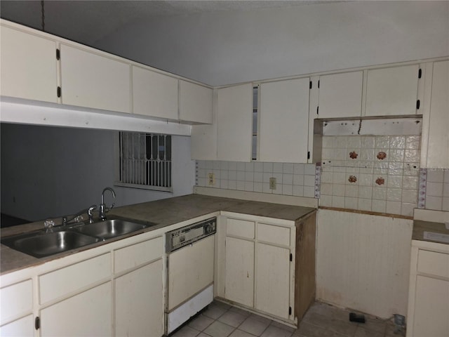 kitchen with dishwasher, sink, light tile patterned floors, white cabinets, and tasteful backsplash