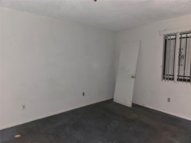 empty room with a textured ceiling