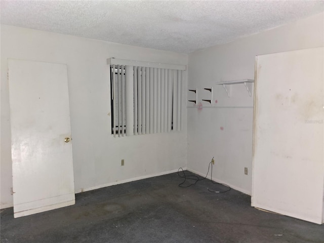 unfurnished room with a textured ceiling