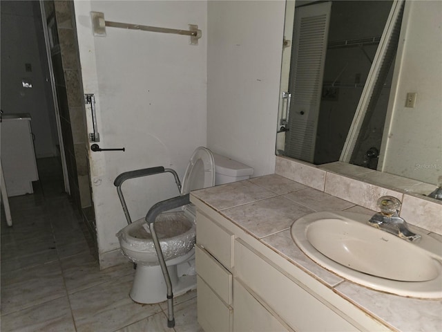 bathroom featuring vanity, toilet, and tile patterned flooring