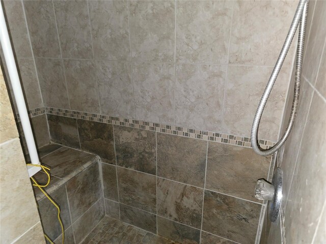 bathroom with a tile shower