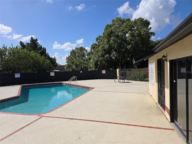 view of swimming pool featuring a patio area