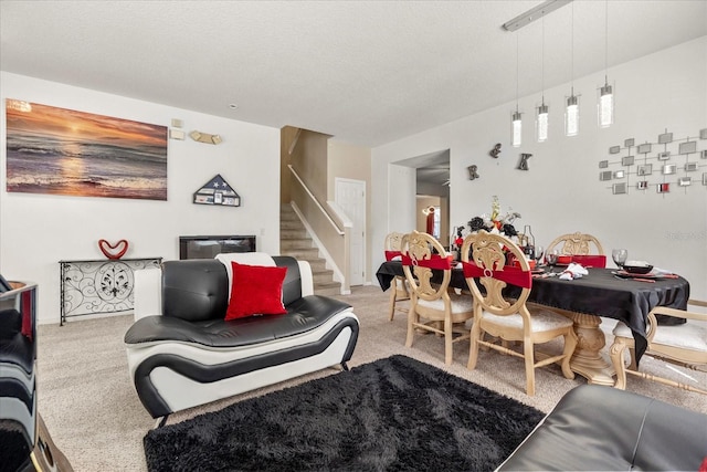 living room featuring carpet and a textured ceiling