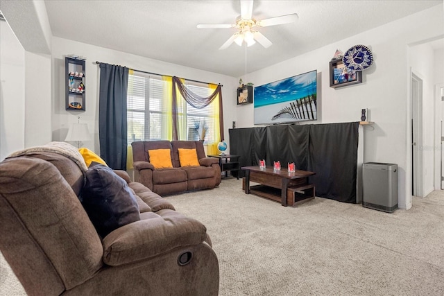 living room with a textured ceiling, carpet, and ceiling fan