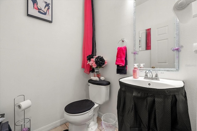 bathroom featuring vanity, tile patterned floors, and toilet