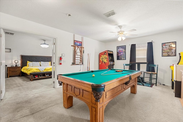 recreation room featuring pool table, a textured ceiling, light colored carpet, and ceiling fan