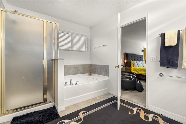 bathroom featuring tile patterned flooring, shower with separate bathtub, and a textured ceiling