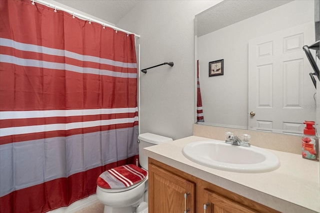 bathroom with vanity, a textured ceiling, toilet, and a shower with curtain