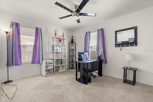 office area featuring ceiling fan, light colored carpet, and a textured ceiling