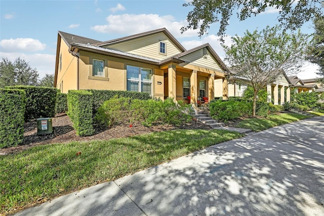 bungalow with stucco siding and covered porch