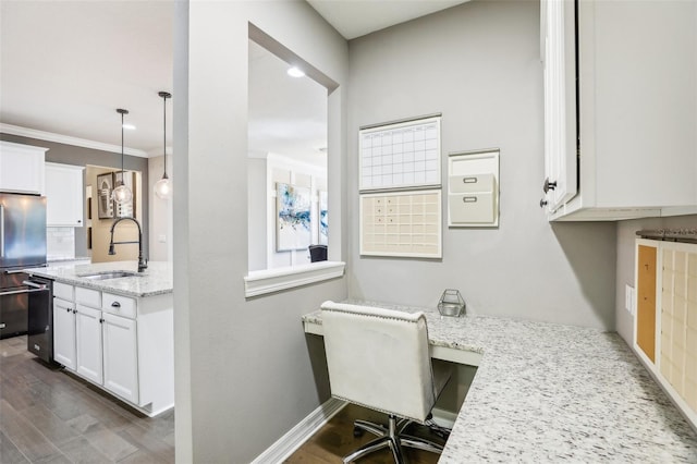 office with built in desk, sink, crown molding, and dark hardwood / wood-style floors