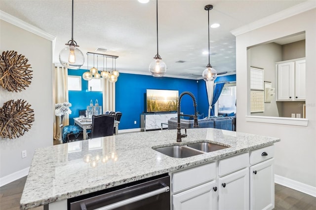 kitchen featuring sink, dark hardwood / wood-style flooring, white cabinetry, crown molding, and a kitchen island with sink