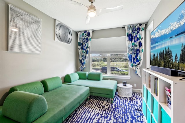 living room with a textured ceiling and ceiling fan