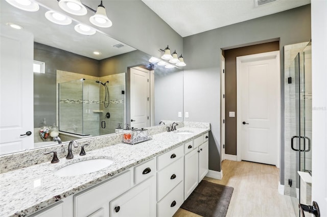 bathroom featuring vanity and an enclosed shower