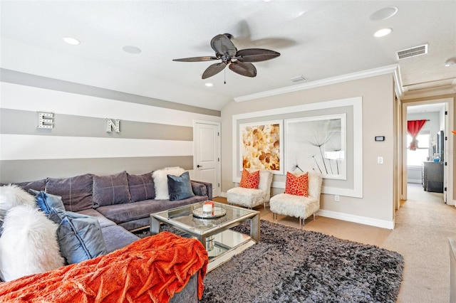 carpeted living room with crown molding and ceiling fan