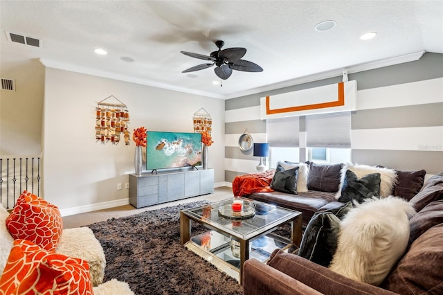 carpeted living room with crown molding, a textured ceiling, and ceiling fan