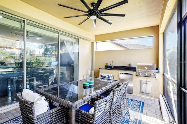 sunroom featuring sink and ceiling fan