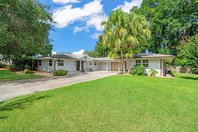 ranch-style house featuring a front lawn and a garage