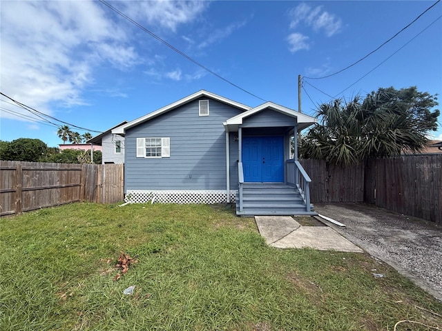 bungalow-style house featuring a front yard