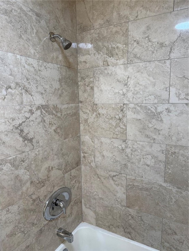 interior details featuring tiled shower / bath