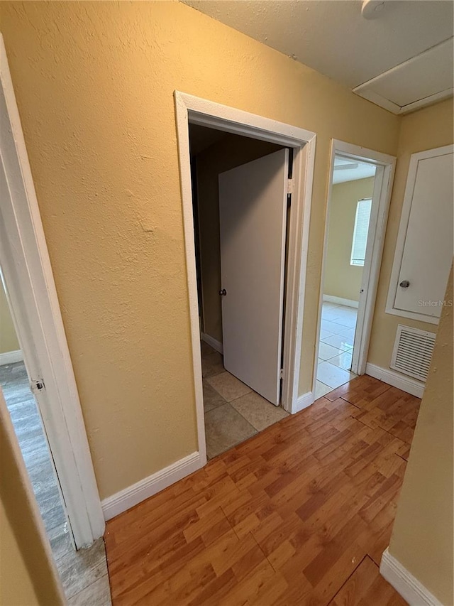 corridor featuring light hardwood / wood-style floors