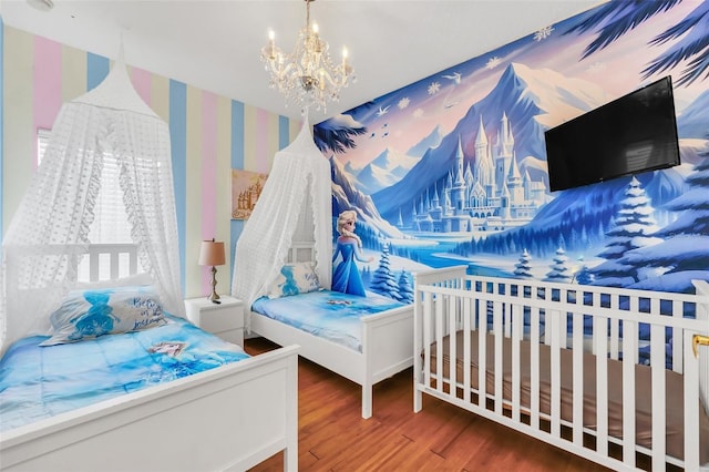 bedroom with an inviting chandelier and hardwood / wood-style floors