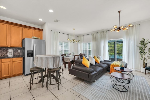 tiled living room featuring a chandelier