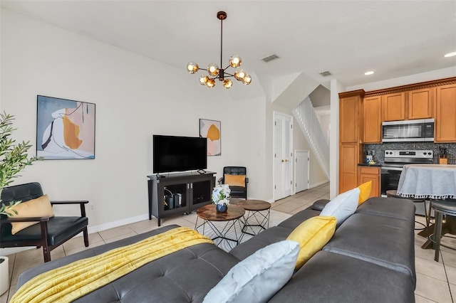 living room featuring light tile patterned floors and an inviting chandelier