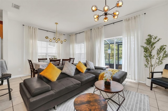 tiled living room with an inviting chandelier