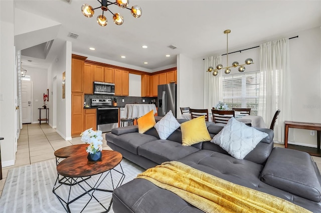 living room featuring an inviting chandelier and light tile patterned floors