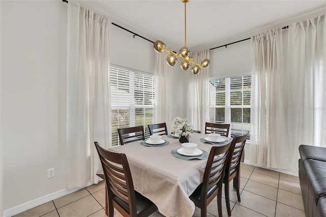 dining room with light tile patterned flooring and a chandelier