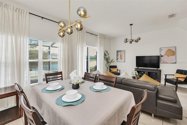 tiled dining area featuring an inviting chandelier