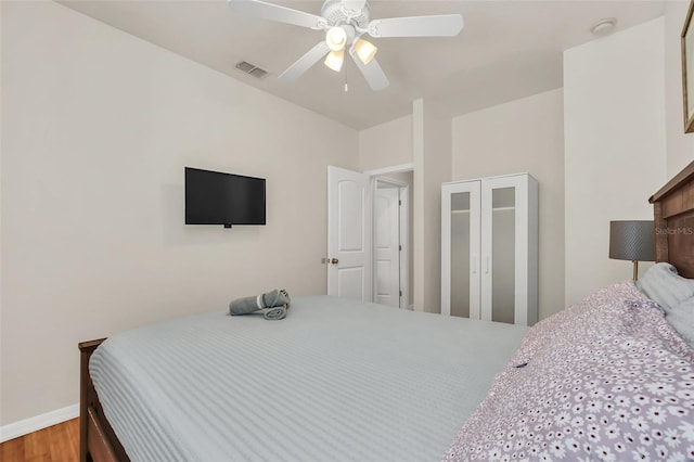 bedroom featuring hardwood / wood-style flooring and ceiling fan