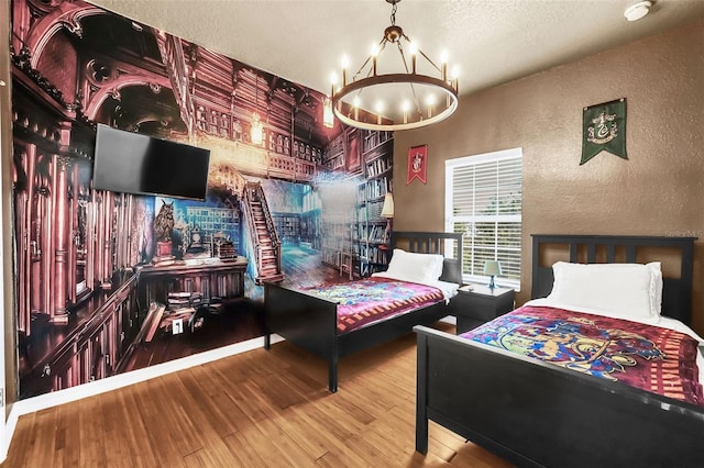 bedroom with hardwood / wood-style floors, a chandelier, and a textured ceiling