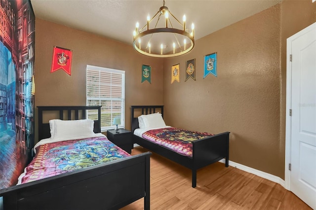 bedroom featuring hardwood / wood-style flooring and a chandelier