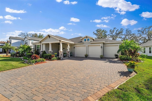 view of front of house with a front lawn, a porch, and a garage