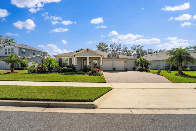 ranch-style home with a front yard, a garage, and covered porch