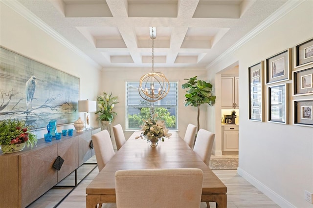 dining area featuring beam ceiling, coffered ceiling, an inviting chandelier, crown molding, and light hardwood / wood-style floors