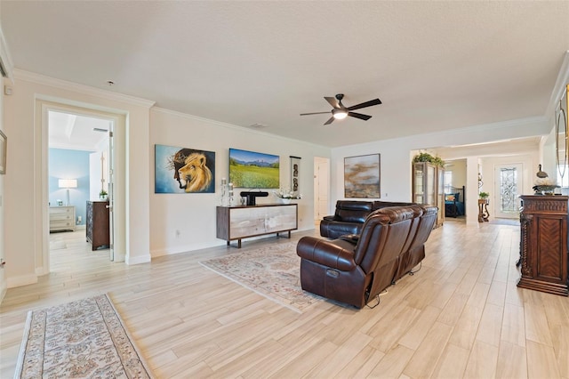 living room featuring light wood-type flooring, ceiling fan, and crown molding