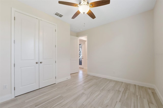 unfurnished bedroom featuring light wood-type flooring, a closet, and ceiling fan