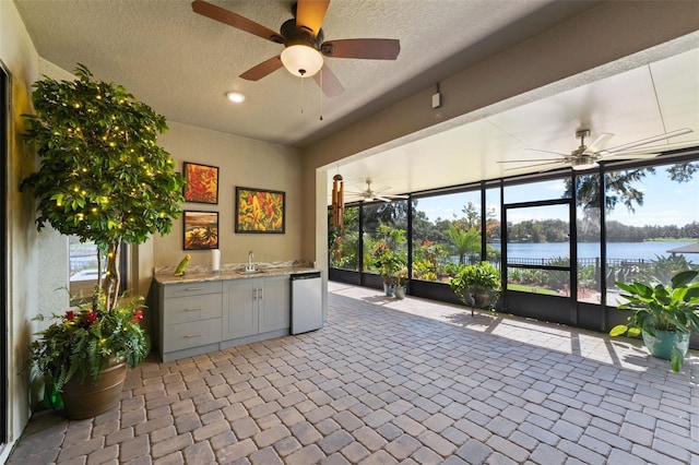 interior space featuring a water view and sink