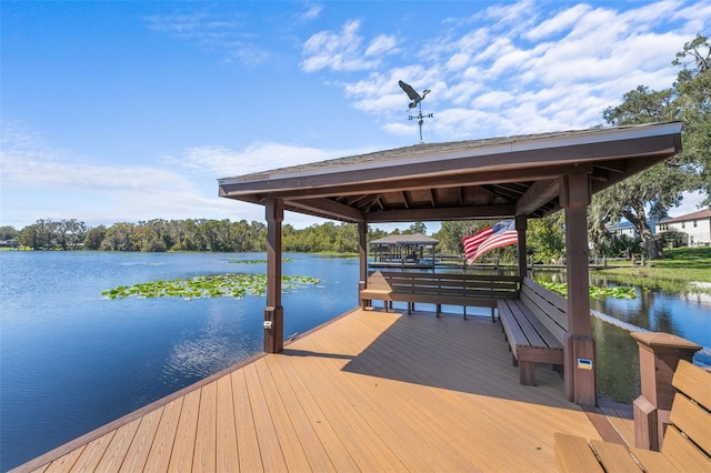 view of dock with a gazebo and a water view